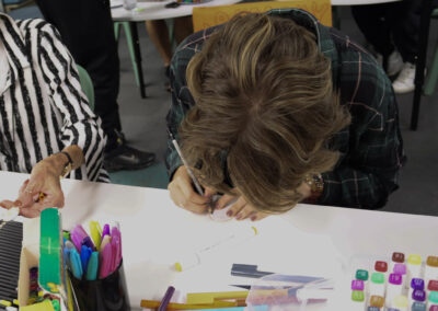 A student drawing the design for their pin badge