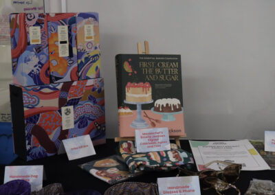 A preview of items on the raffle table, including a cookbook and a hair and skin care gift box