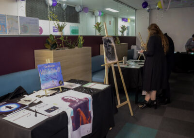 A close-up of auction items on display with guests viewing them